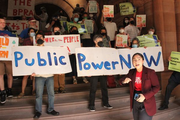 Kristen Gonzalez in Albany speaking in front of activists holding Public Power signs